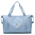 Light blue durable nylon travel duffel bag with reinforced handles and a labeled patch designed for maroon wet separation sports