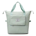 A light mint green foldable travel bag with sturdy handles and label designed for maroon wet separation sports use