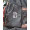 Dark gray fabric travel bag with rose gold trim and label designed for maroon wet separation sports use