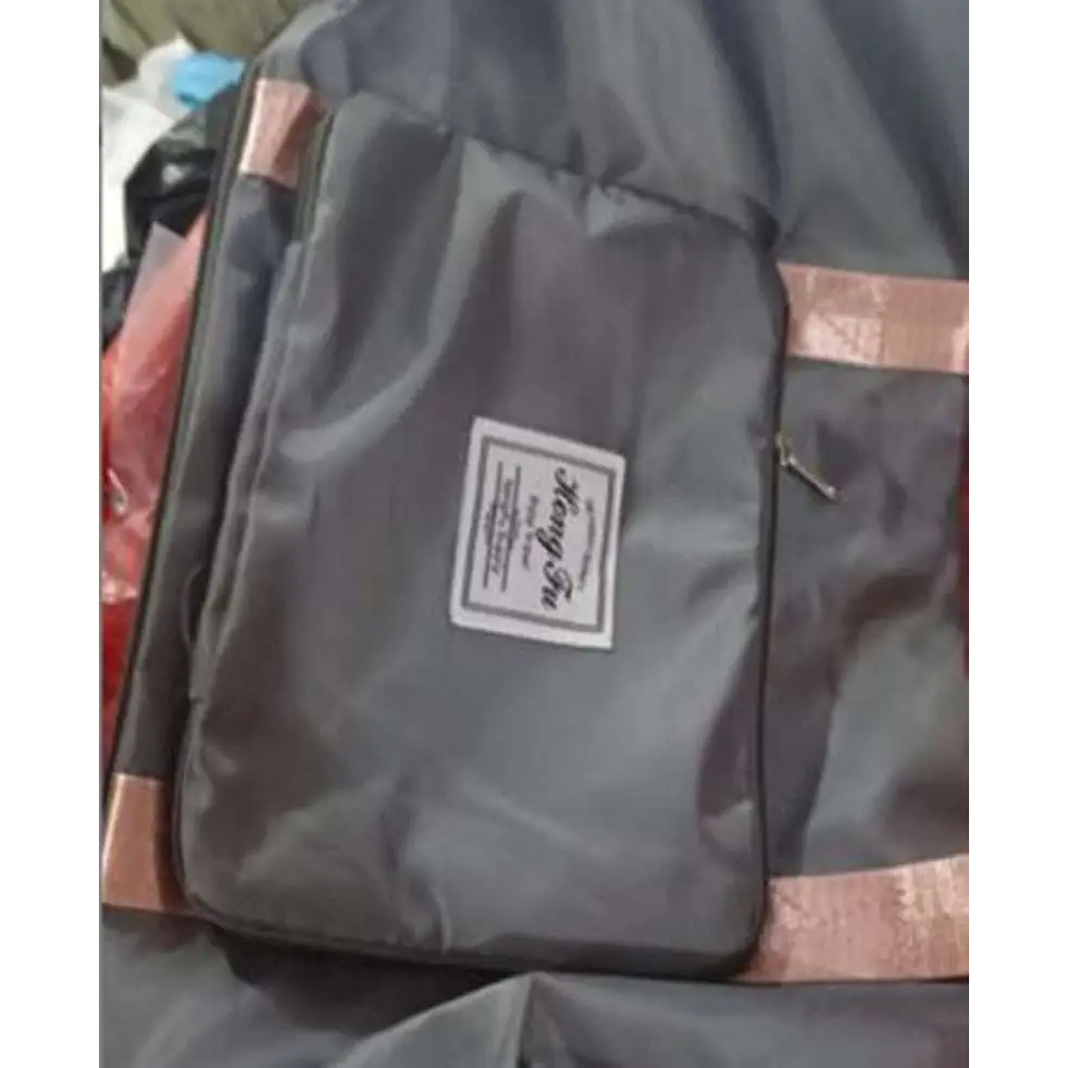Dark gray fabric travel bag with rose gold trim and label designed for maroon wet separation sports use
