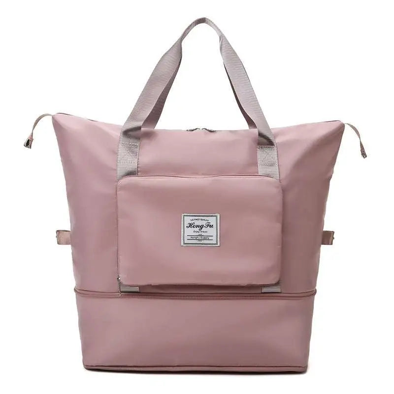 A soft pink maroon wet separation sports bag with gray handles and a front pocket featuring a label designed for travel