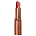 Matte luxe lipstick in cheeky chat features a matte red bullet in a rose gold case with vertical ridges and nourishing formula