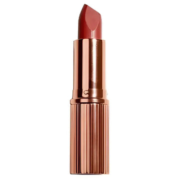 Matte luxe lipstick in cheeky chat with matte red bullet and rose gold case featuring vertical ridges and nourishing formula