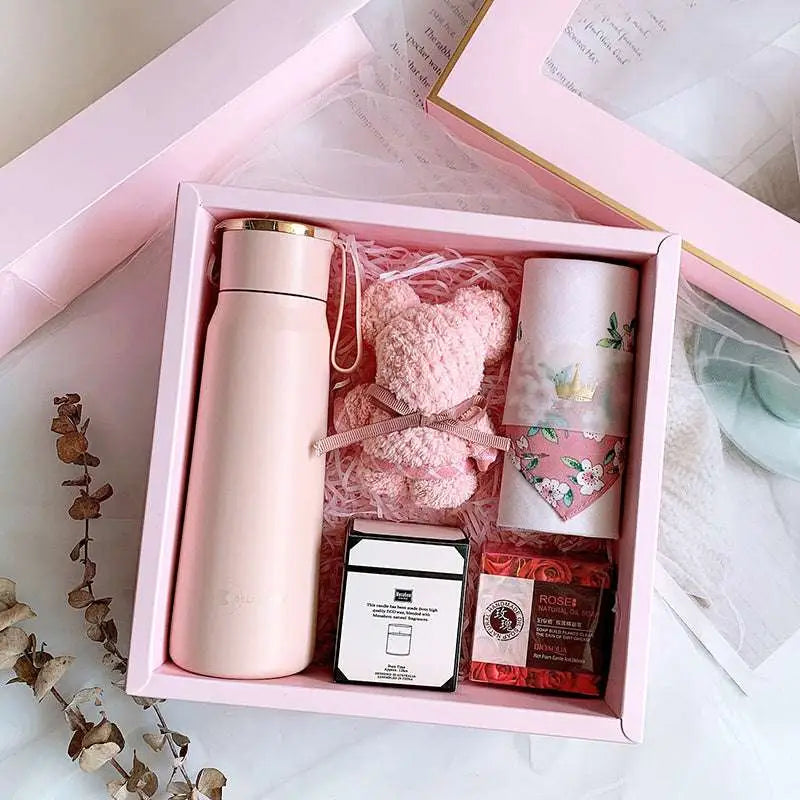 A sleek matte pink vacuum flask with gold lid and carrying loop in a corporate gift box, ideal for aromatherapy tablets