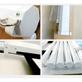 Matte white motorized projection screen with a white plastic retractable curtain rod and metallic ring for enhanced viewing area