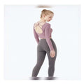 Mauve crisscross strap long sleeve yoga crop top shown from the back paired with dark gray leggings