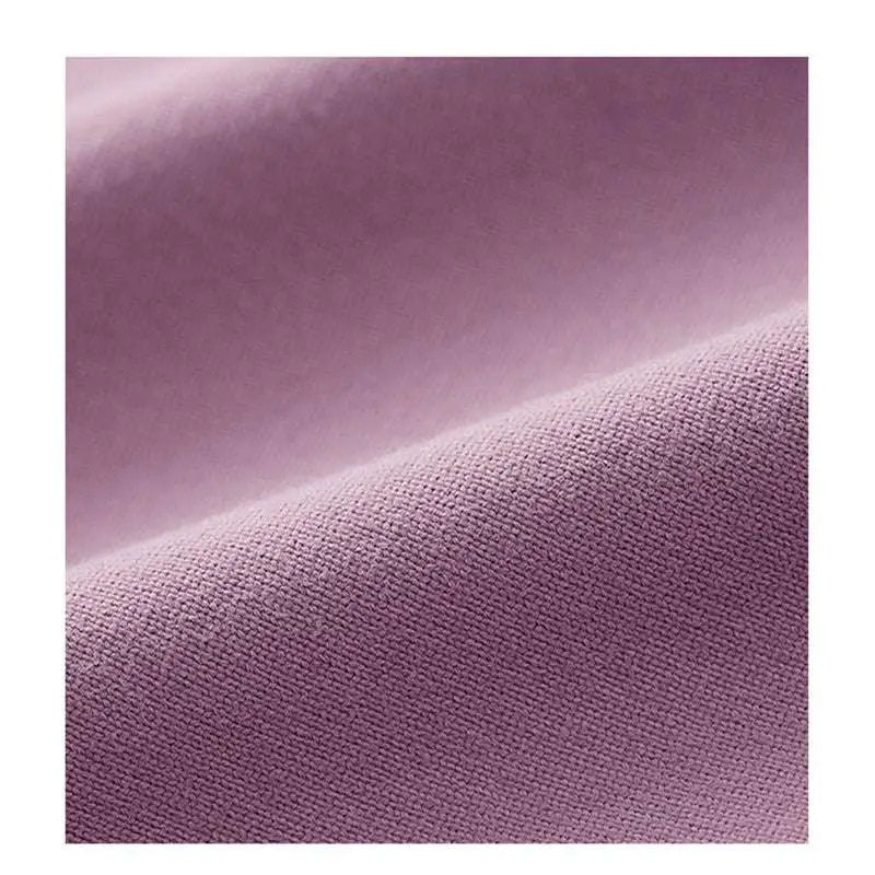 A soft lavender mauve crisscross strap long sleeve yoga crop top made of subtly textured woven fabric
