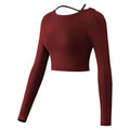 Mauve crisscross strap long sleeve yoga crop top shown from the back with a tie detail in maroon fabric