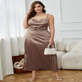 Flowing taupe satin slip dress with draped neckline and fitted waist in a mauve satin plus size sling style with high slit