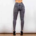 Back view of melody high waist gray denim leggings featuring form-fitting design and functional back pockets