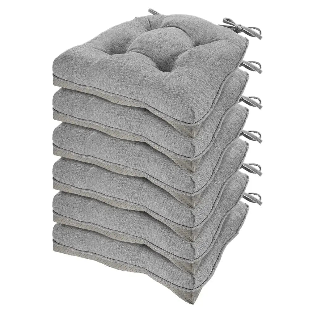 Stack of six gray tufted memory foam chair cushions with ties designed for dining chair comfort and support