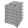 Stack of six gray tufted fabric memory foam chair cushions with tied ties for dining chairs set of 6