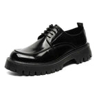 Men’s casual black patent leather oxford shoe with glossy finish, red stitching, and chunky textured rubber sole