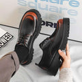 Men’s casual black leather shoes with red stitching, chunky rubber sole, and subtle reddish-brown toe cap accents