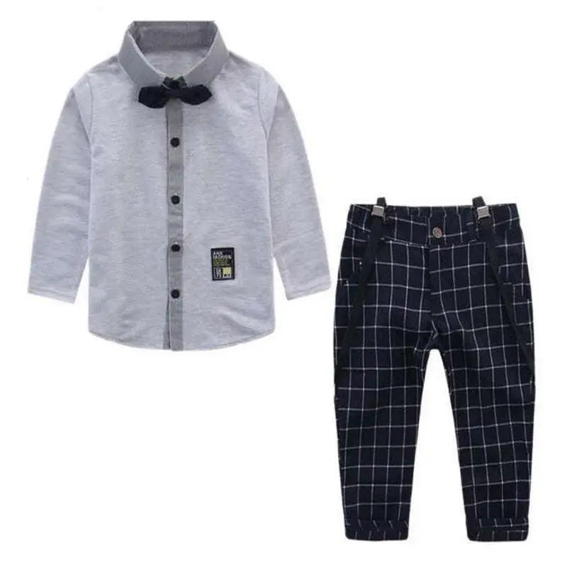 Men’s plaid suspenders treasure suit featuring gray long-sleeved shirt with black bow tie and navy blue plaid pants with suspenders