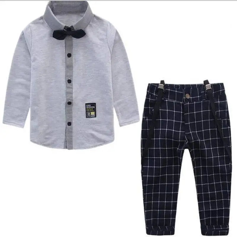 Men’s plaid suspenders treasure suit featuring gray long-sleeved shirt with black bow tie and navy blue plaid pants with suspenders