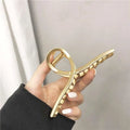 Gold shark clip metal hair claw with textured ridges showcasing korean elegant temperament and white pearls design