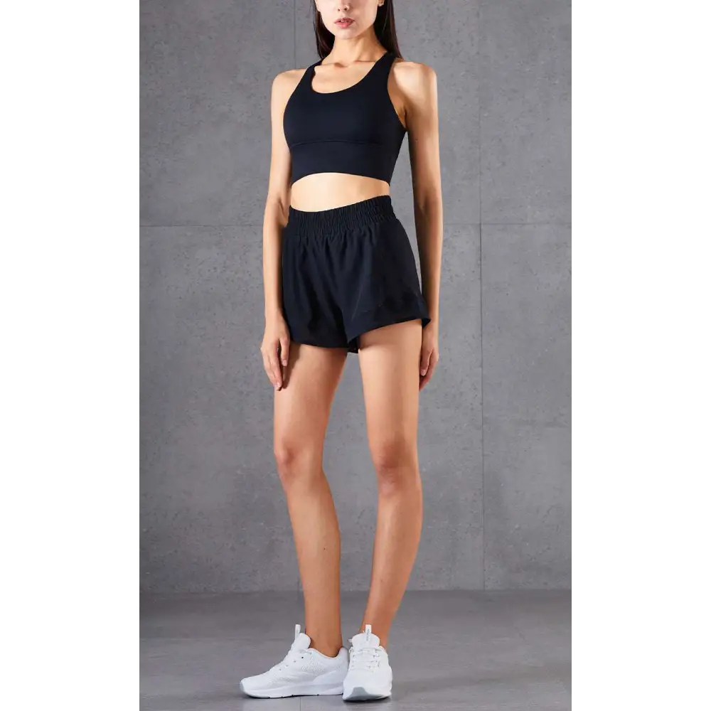 Black athletic crop top with racerback design and seamless construction in mesh pockets fitness two-piece athletic set