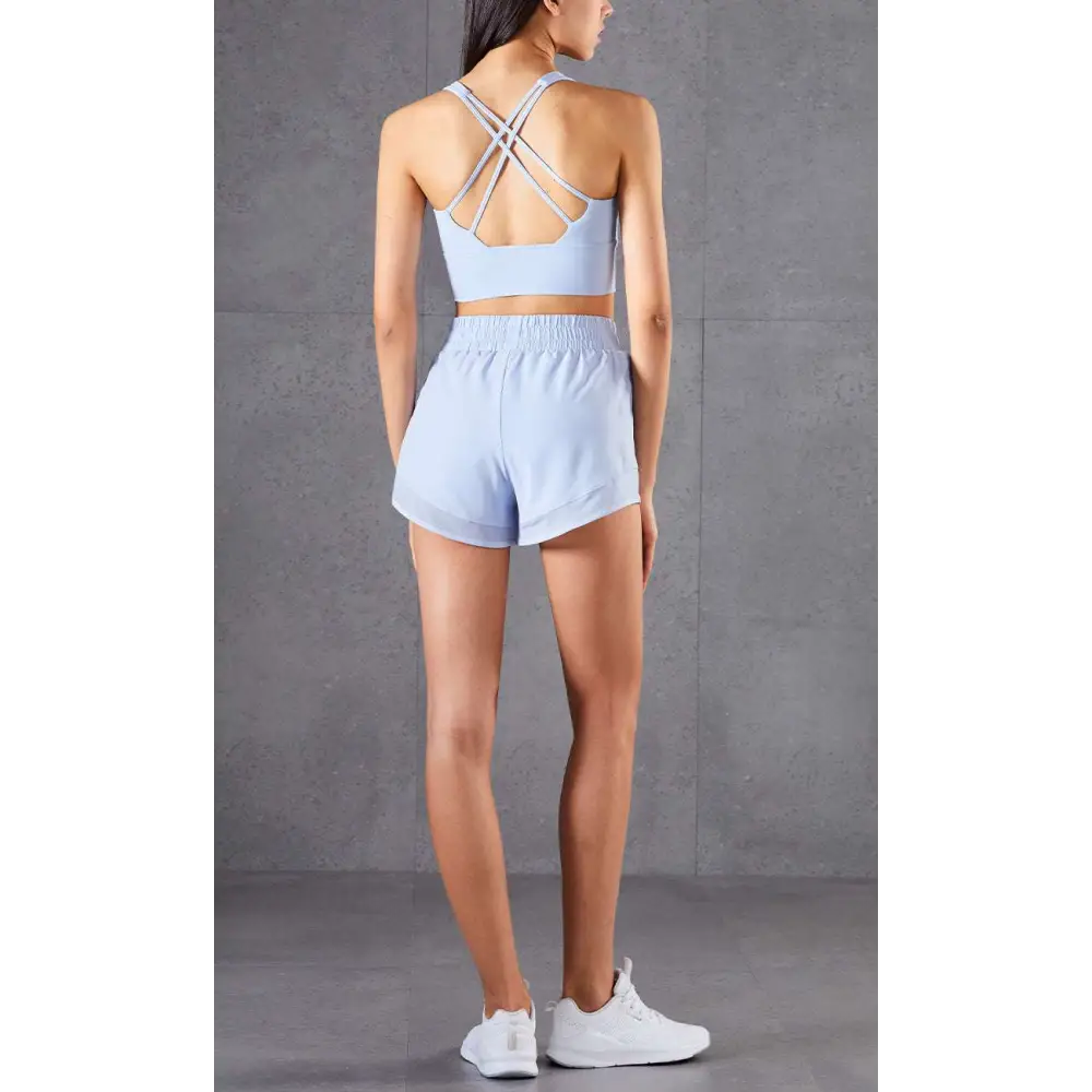 Light blue mesh pockets fitness two-piece athletic set with breathable crop top and high-waisted shorts back view