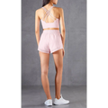 Pink two-piece athletic set with mesh pockets breathable fitness pants and crisscross back straps shown from back side