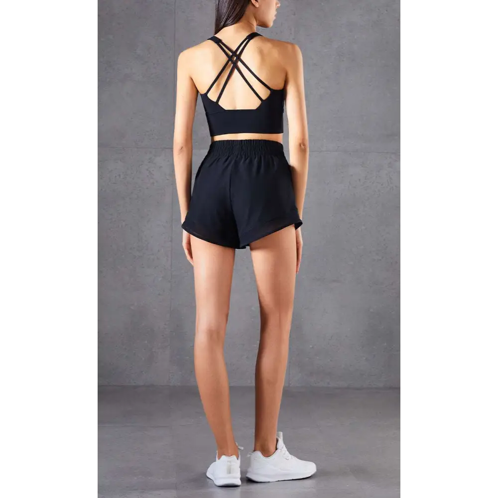 Black two-piece athletic set with mesh pockets fitness breathable crop top with crisscross back straps and shorts
