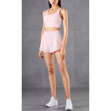 A soft pink two-piece athletic set with breathable fitness pants and mesh pockets for enhanced comfort and functionality