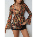 A women’s sheer floral romper with long knotted flare sleeves and a deep v-neck tie-front mesh printed knotted design