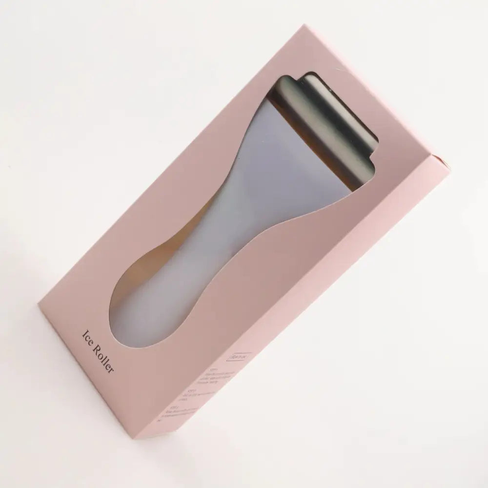 A sleek metallic ice roller with matte lavender handle and polished metal head for skin cooling spa treatment