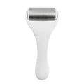 Metallic ice roller with white handle and brushed stainless steel head for skin cooling spa treatment use