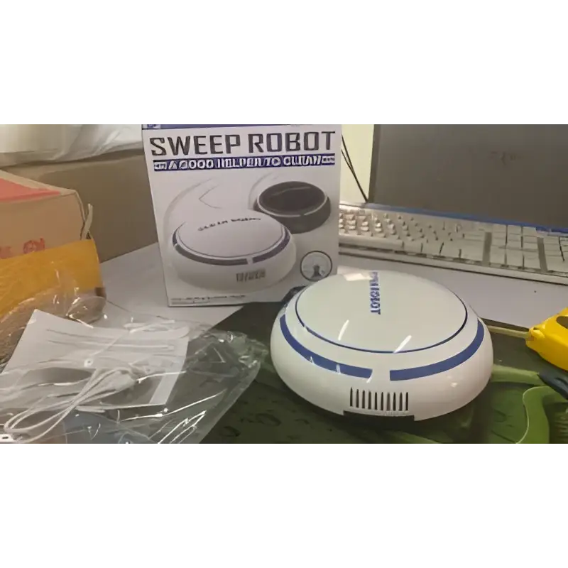 White and blue circular mini desktop robot vacuum with sleek modern design for efficient desktop cleaning tasks