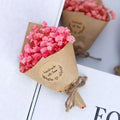 A delicate vibrant pink dried flower bouquet wrapped in rustic kraft paper and twine for home decoration gift box