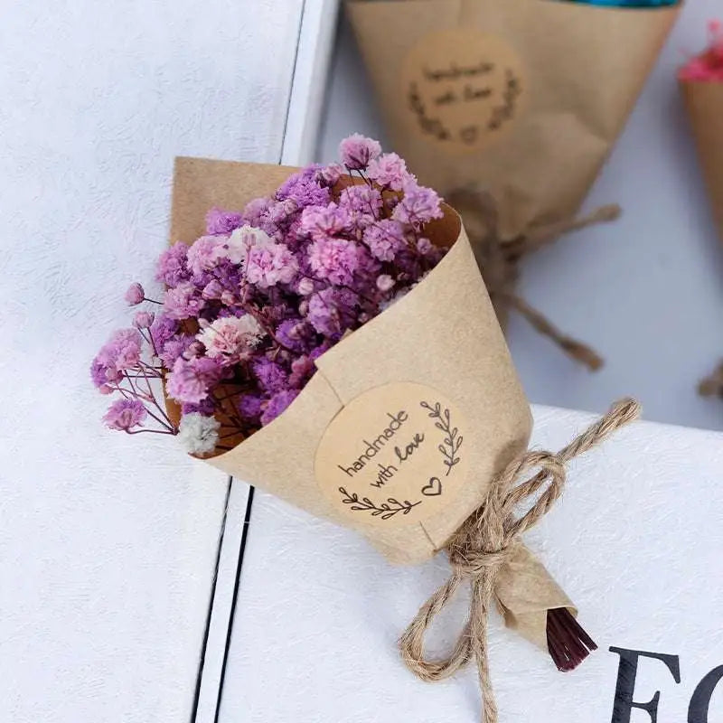 A delicate mini dried flower bouquet gift box featuring baby’s breath wrapped in brown kraft paper for home decoration