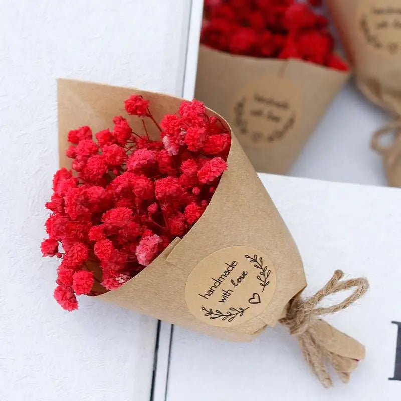 A vibrant red dried flower bouquet wrapped in kraft paper with twine and a handmade with love label perfect for home decoration