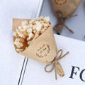 Mini dried flower bouquet gift box featuring a delicate white baby’s breath dried flower bouquet wrapped in kraft paper for home decoration