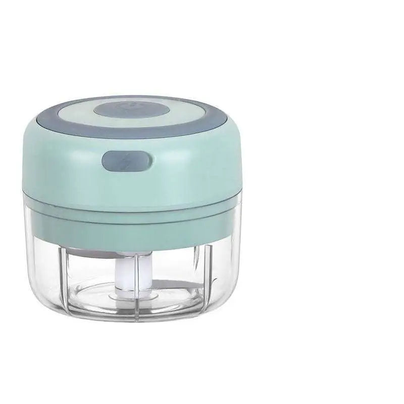 A compact mint green electric garlic chopper with transparent glass bowl and stainless steel blade for easy chopping