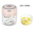 Mini electric garlic chopper with pink and clear plastic body, gray top, stainless steel blade, and glass bowl container