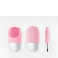 Mini silicone electric facial cleanser brush with pink and white soft silicone bristles for gentle skin cleansing