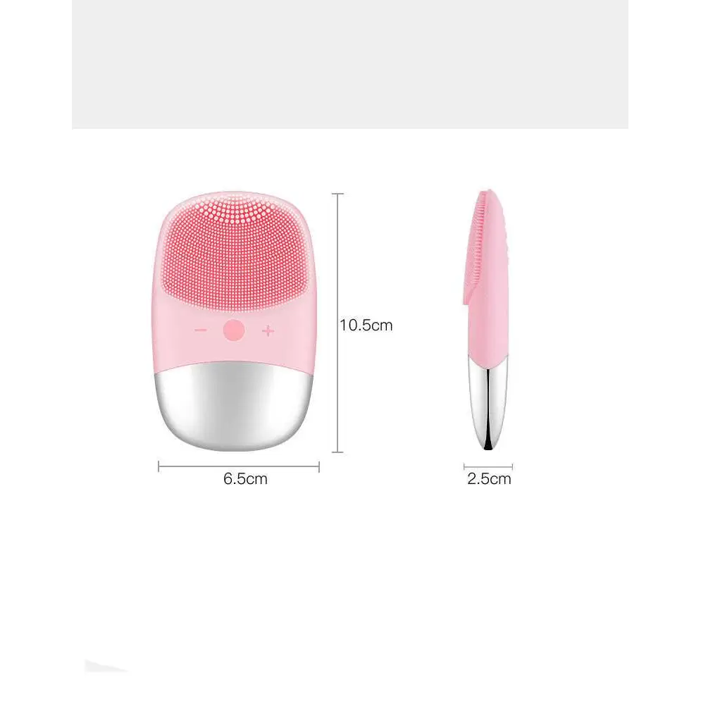 Mini silicone electric facial cleanser brush in pink and silver with soft silicone bristles for gentle cleansing