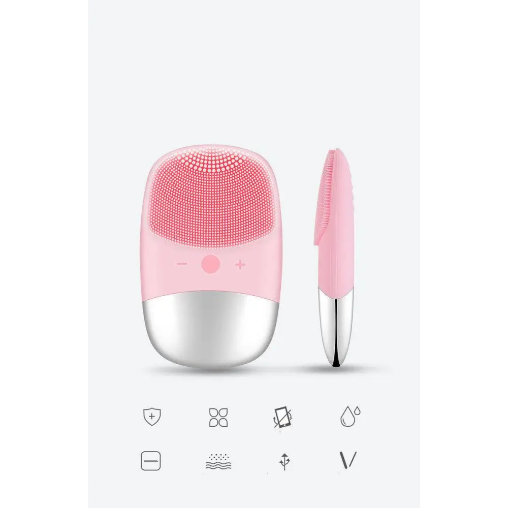 Mini silicone electric facial cleanser brush with pink and silver body and soft silicone bristles for gentle cleansing