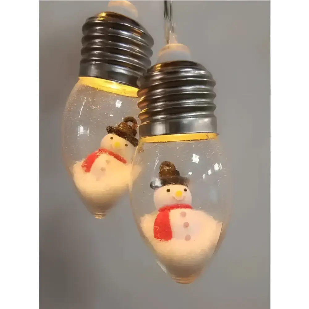 Clear glass christmas led string decorative lights with silver bases and miniature snowman scene inside bulbs
