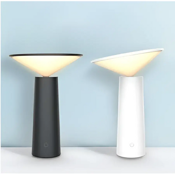 Two minimalist touch table lamps with sleek cylindrical bases and usb led softly glowing shades in black and white