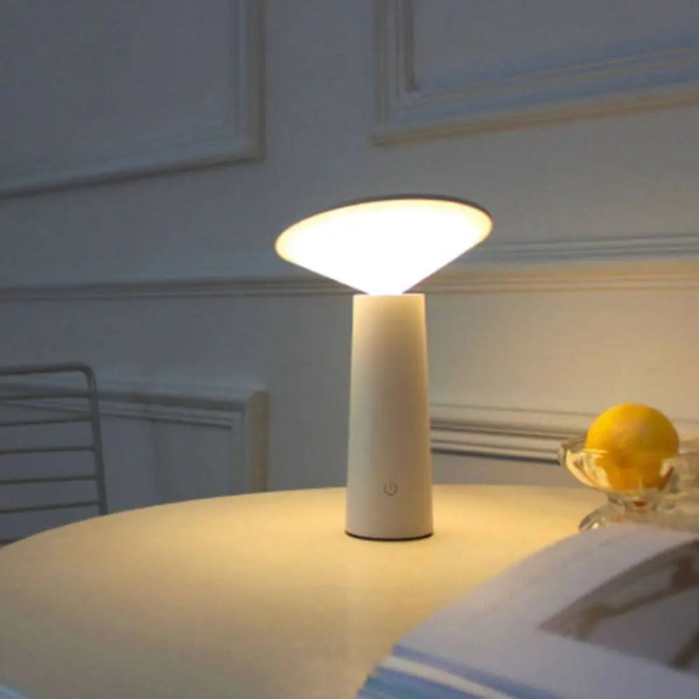 Minimalist touch table lamp usb led with a sleek white cylindrical base and flat circular shade emitting warm light