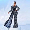 Black and silver sequined evening dress with long sleeves high waistband and flowing sheer train for formal events