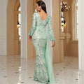 Back view of a shimmering mint green long sleeve sexy sequined evening dress with an elegant backless mermaid design