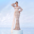 A shimmering rose gold sequined evening dress with long sleeves and a flowing sheer mermaid train