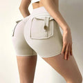 Beige high waisted feel pocket yoga shorts with buttoned front pocket and side ties in mint green nude style