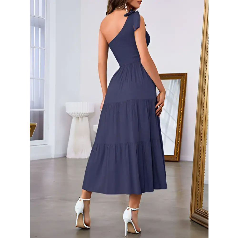 Navy blue one-shoulder tiered maxi dress with bow detail paired with mint green pleated layered hem split dress
