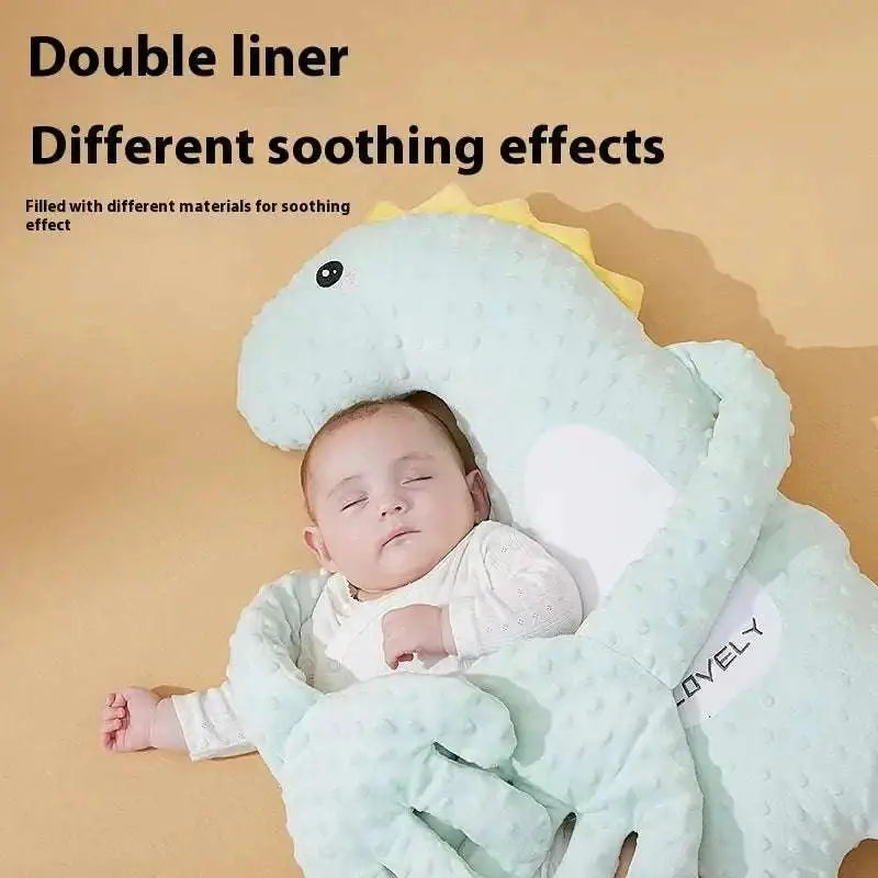 Mint green plush dinosaur baby pillow in light blue textured fabric with yellow spikes and white inner lining