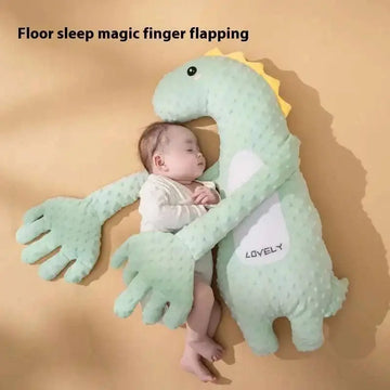 Mint green plush dinosaur baby pillow featuring soft yellow spines and white belly accents for nursery comfort
