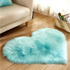 A mint green plush heart shaped living room rug with a soft faux fur texture and light turquoise color